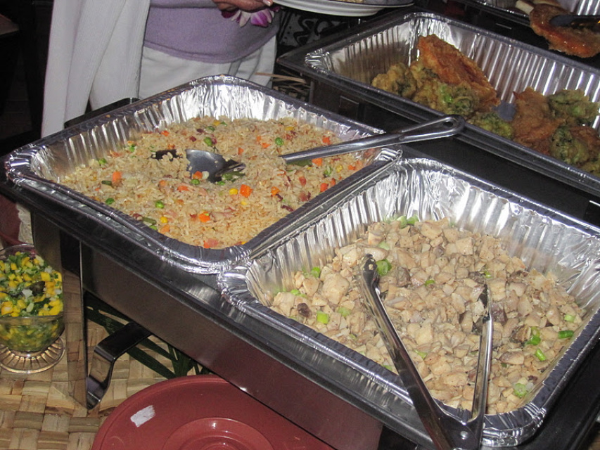 Tropical Hawaiian food buffet spread with pineapple rice and dishes