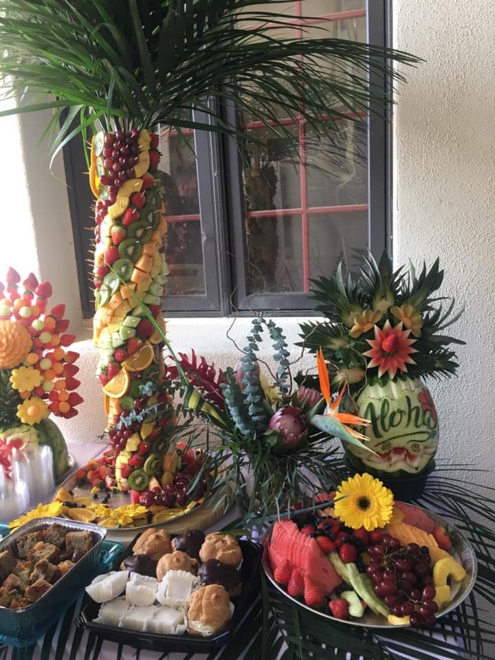 Hawaiian luau venue decorated with palm leaves and tropical flowers