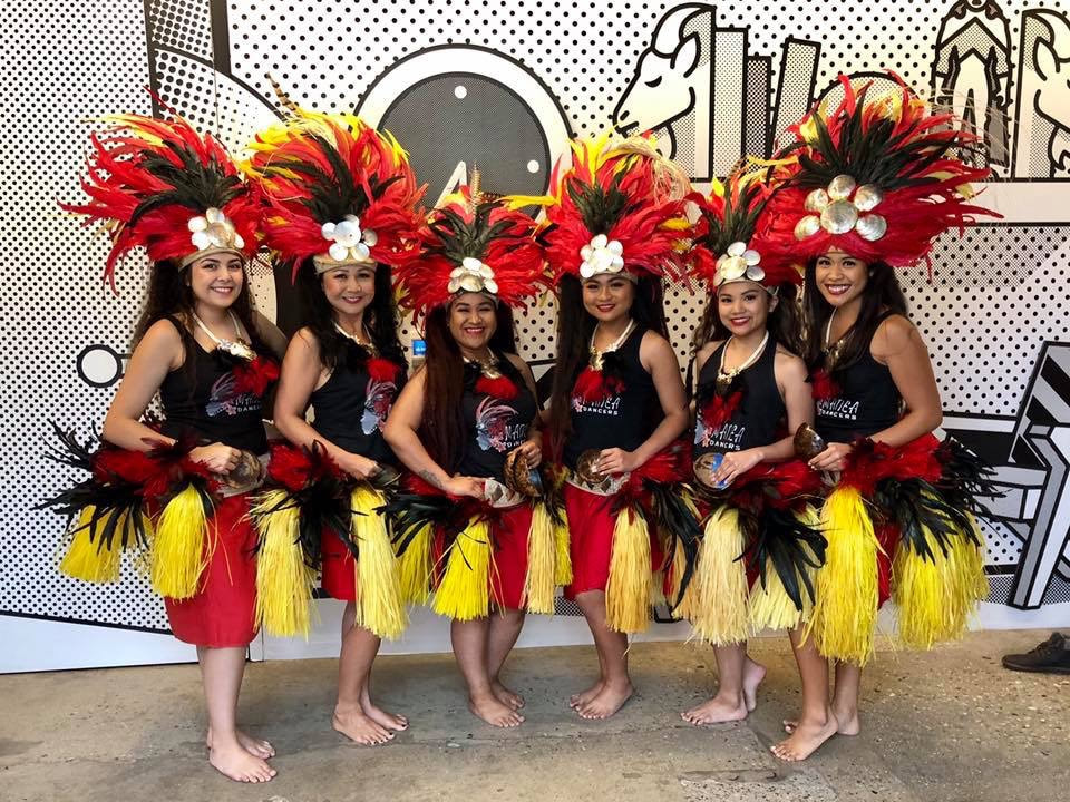 Hawaiian hula dancers group performance with lei flowers