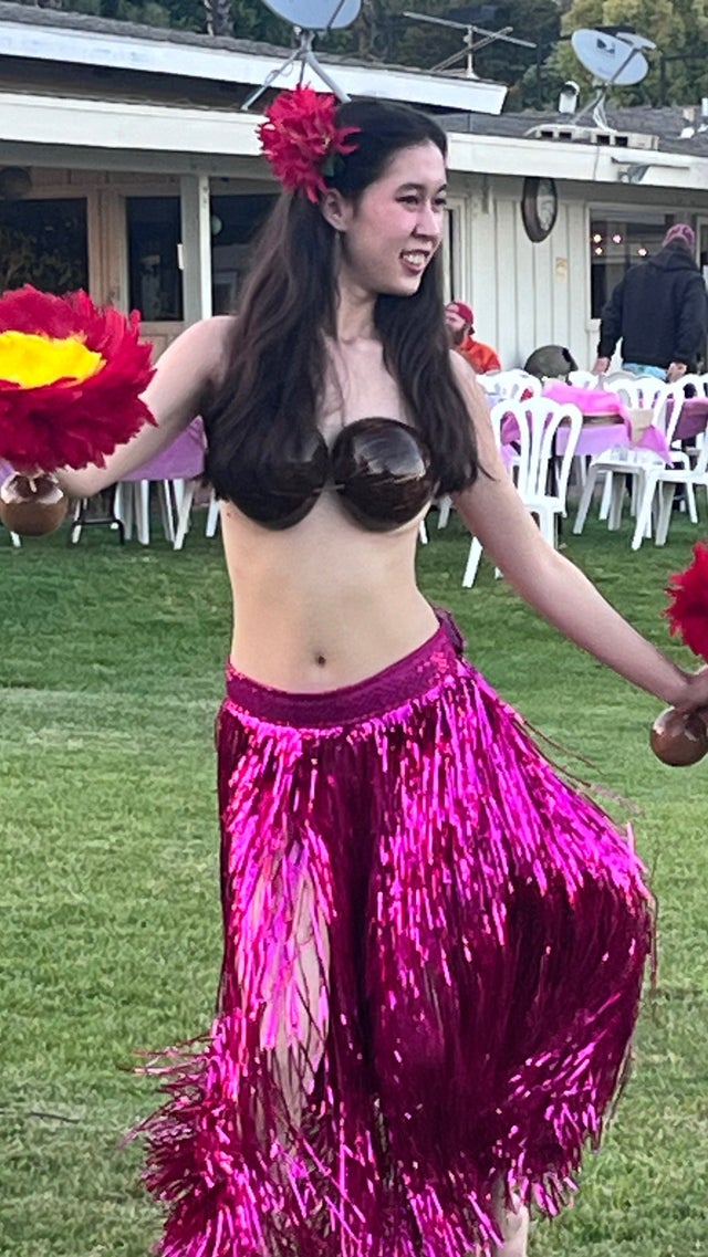 Outdoor tropical luau party event setup with guests and decorations