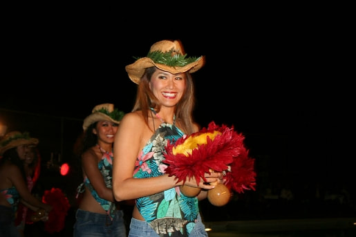 Luau party crowd celebrating at a tropical outdoor event