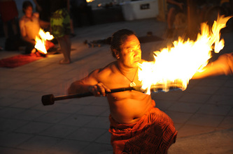 Fire breathing performer at a tiki torch luau entertainment show